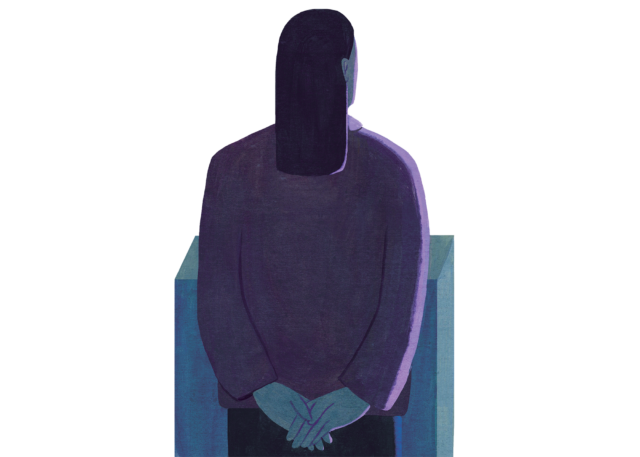 A person standing with the hands clasped behind their back