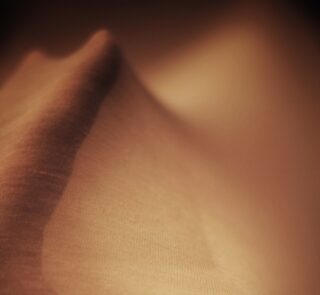 A hand pressed against fabric