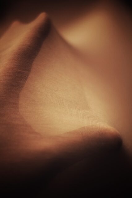 A hand pressed against fabric