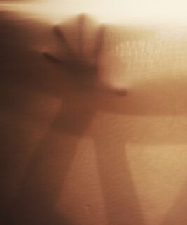 A hand pressed against fabric